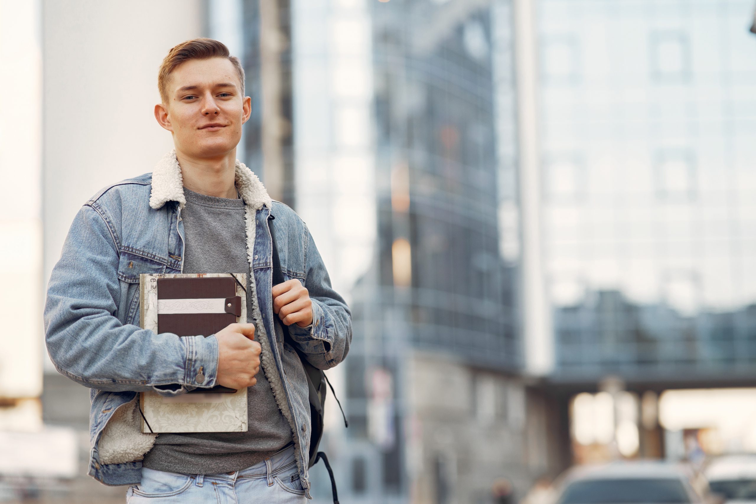 Student in a university campus with a books