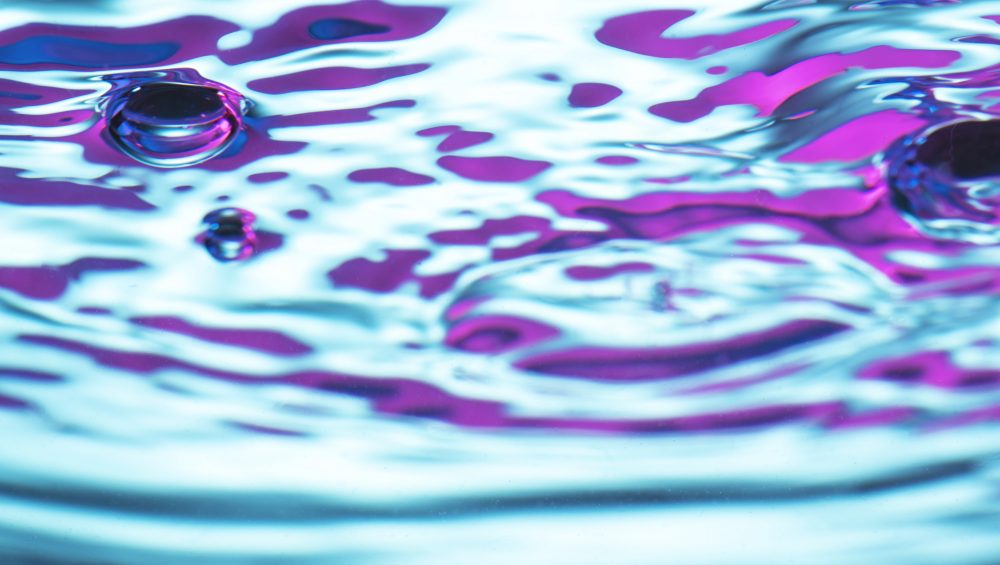 Abstract background image of neon coloured water.