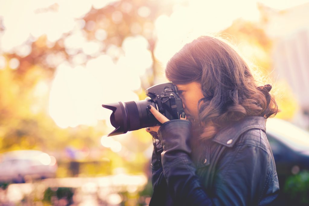 Woman taking photo with digital camera.