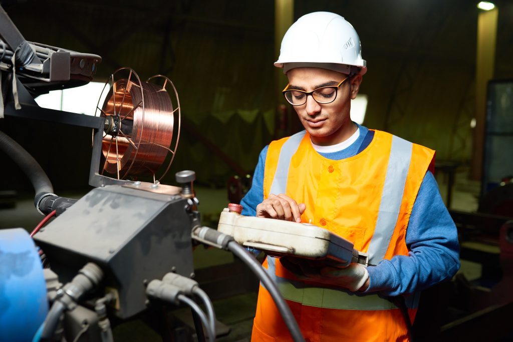 Engineer operating factory equipment.