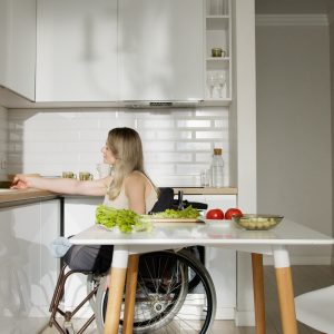 person in wheelchair in a kitchen