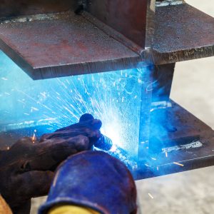 Person welding large metal plates.