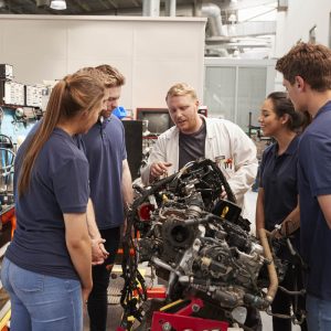 Lecture teaching learners in automotive workshop