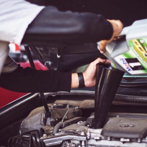 Pouring oil into car engine