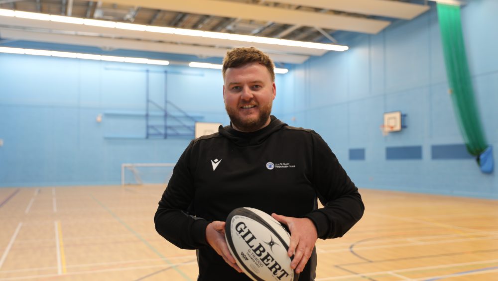 WRU Rugby Officer, Aled holding a rugby ball