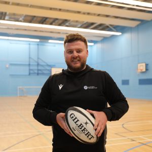 WRU Rugby Officer, Aled holding a rugby ball