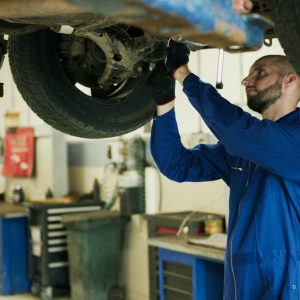 man working on the underside of a car