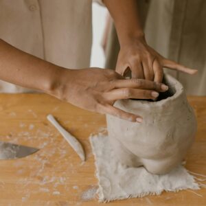 hands sculpting clay
