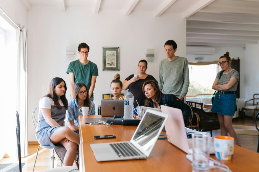 group of people around laptops
