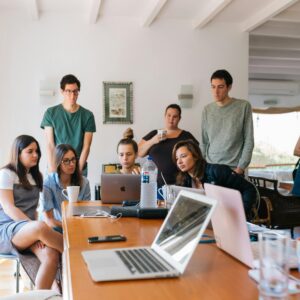 group of people around laptops