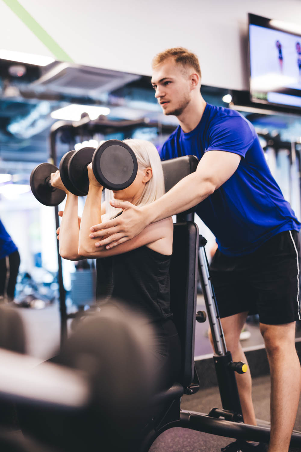 Woman exercising with personal trainer.