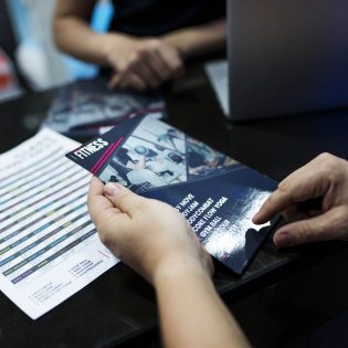 hands holding fitness flyer