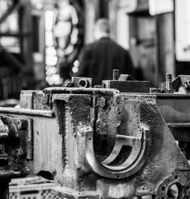 Black and white photo of metal in engineering workshop.