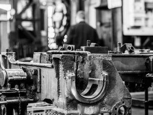 Black and white photo of metal in engineering workshop.