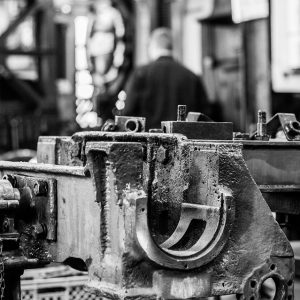 Black and white photo of metal in engineering workshop.