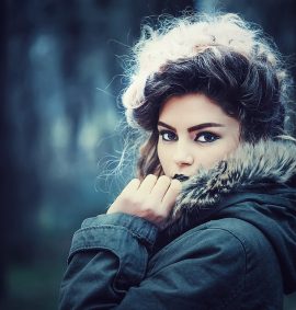 Woman with perfect make-up wearing fur coat.