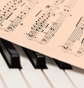 Sheet music on piano keys.