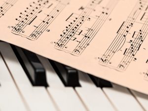 Sheet music on piano keys.