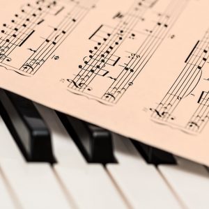Sheet music on piano keys.