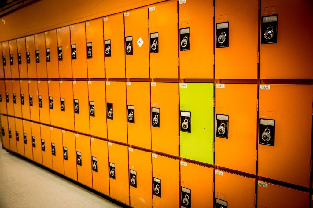 Rows of orange lockers and one yellow locker.