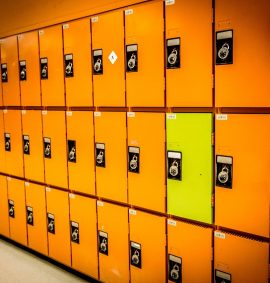 Rows of orange lockers and one yellow locker.