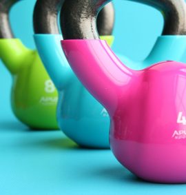 Three bright coloured kettle bells.