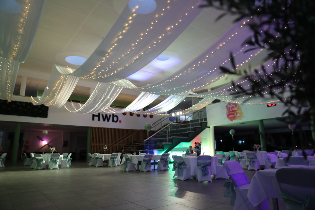 College atrium dressed with white drapes and fairylights