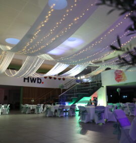 College atrium dressed with white drapes and fairylights