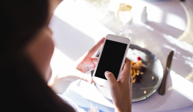 Close up of woman taking a photo of food