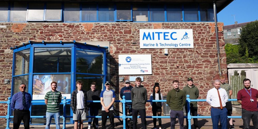 Scholarship students standing outside MITEC building.