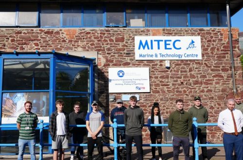 Scholarship students standing outside MITEC building.