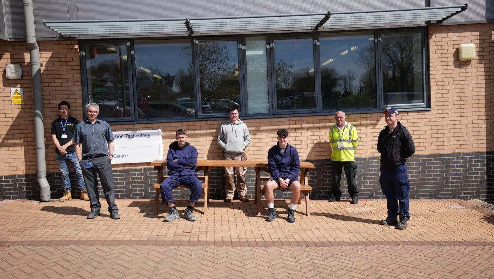 Learners and staff outside with Unison Bench.