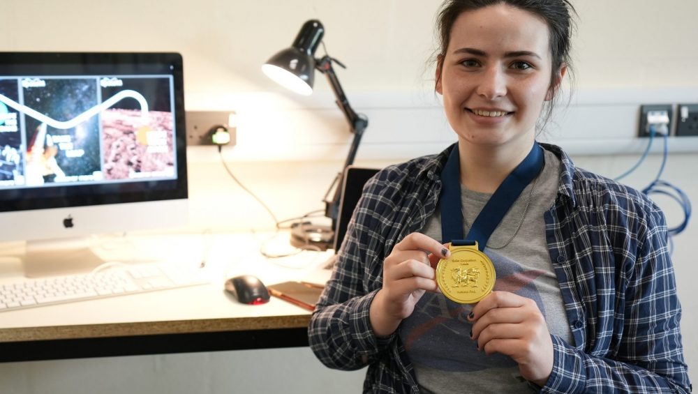 Zoe holding medal.