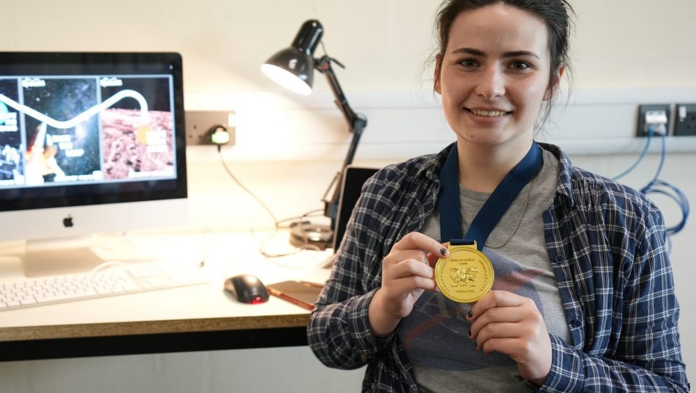 Zoe Price holding medal.