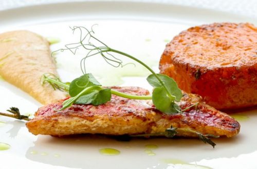 Plate of food, grilled chicken fillet, fondant potato and a sauce.
