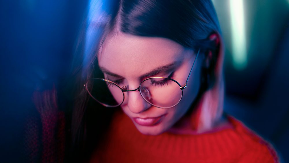Lady wearing glasses looking down