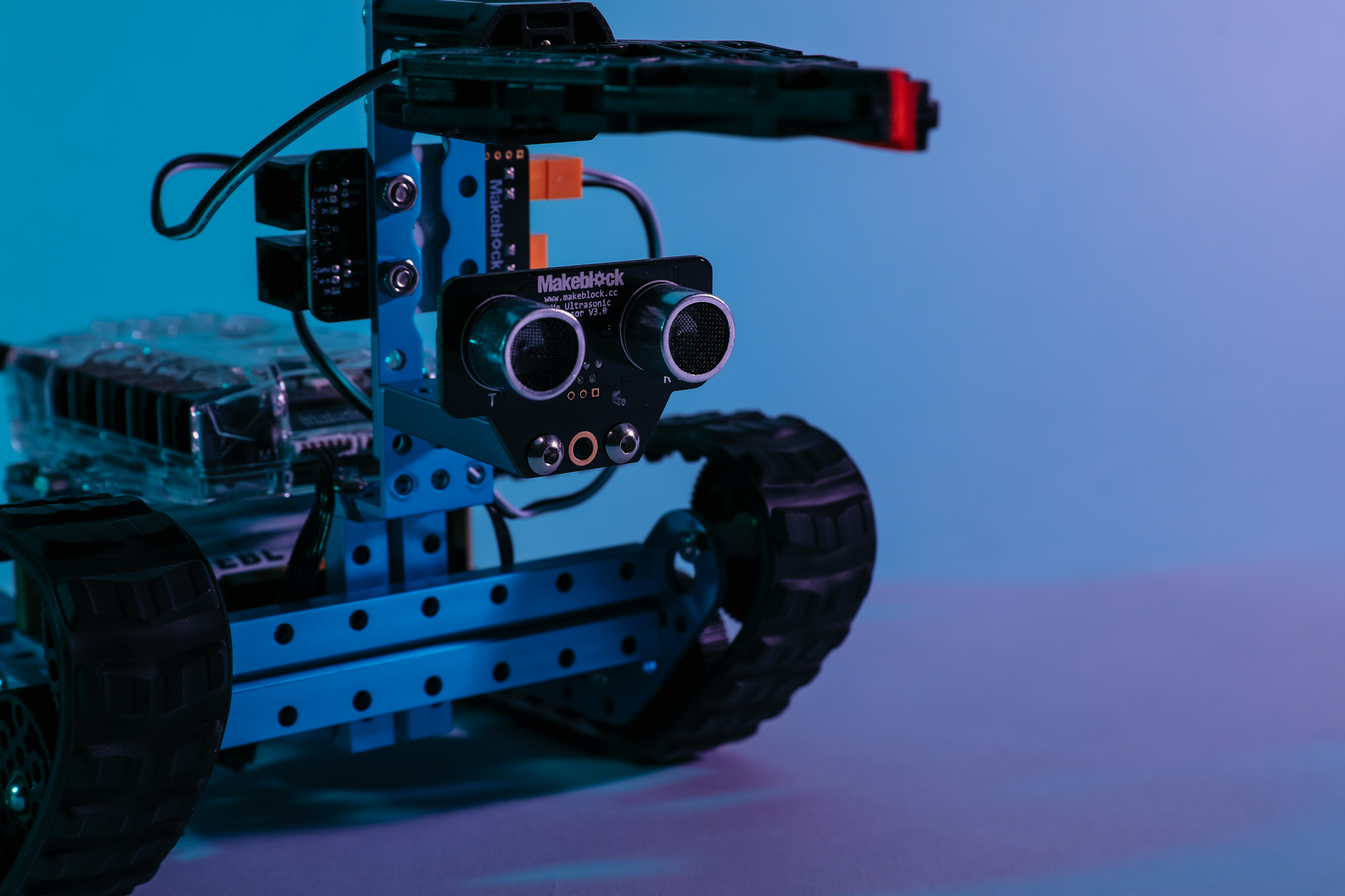 Close up photo of robot with tracks and claw