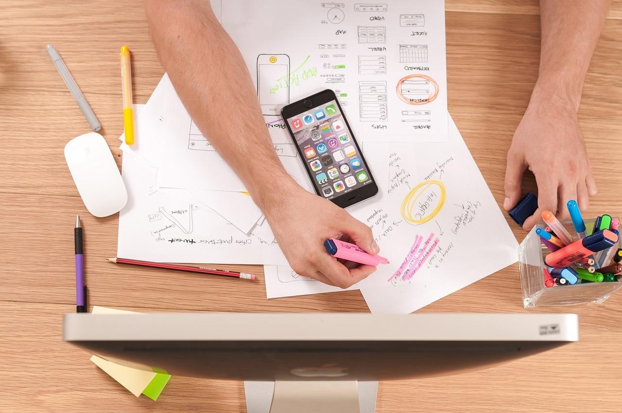 desk from above, highlighted areas, a phone and the top of a computer