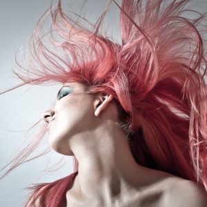 Person doing a Pink Hair Toss creating a feather effect