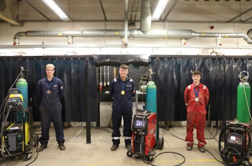 Ross, Joel & Cohen standing in welding workshop.