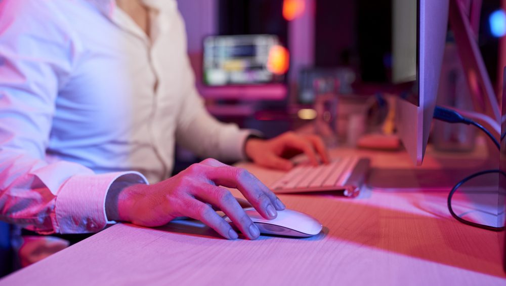 Cropped image of person using a computer.