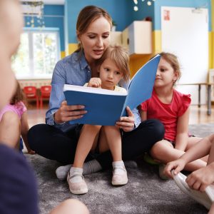 Teacher reading to children.