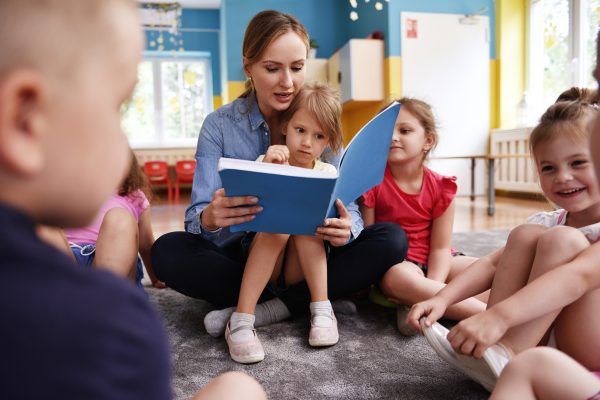 Teacher reading to children.