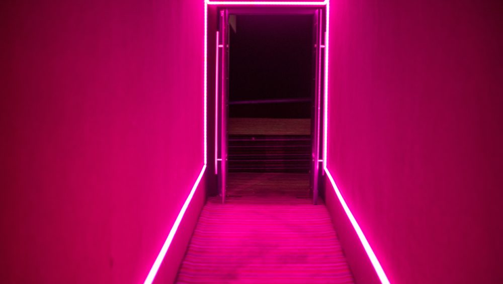 Doorway surrounded by pink neon lights