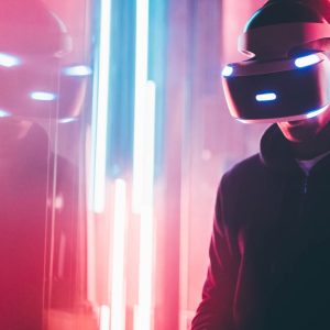 Person wearing a VR headset next to neon lights