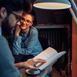 Couple studying in cosy coffee shop.