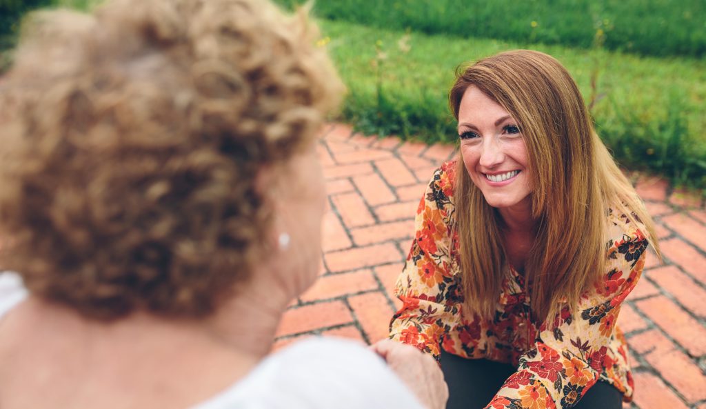 Woman talking in older woman.