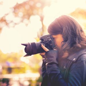 Woman taking photo with digital camera.