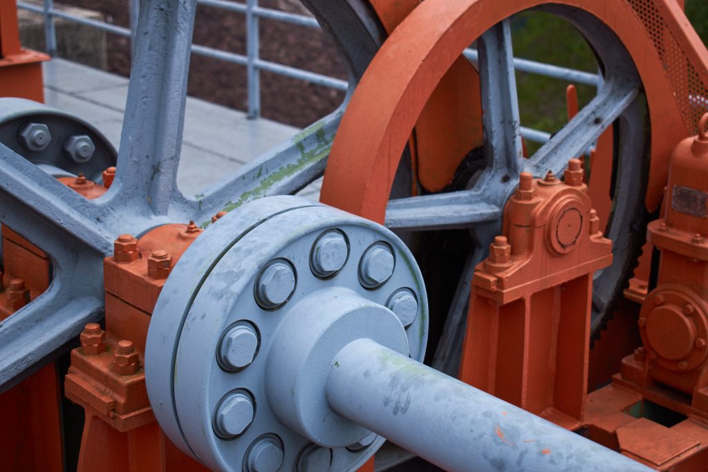 Close up of large mechanical wheels.