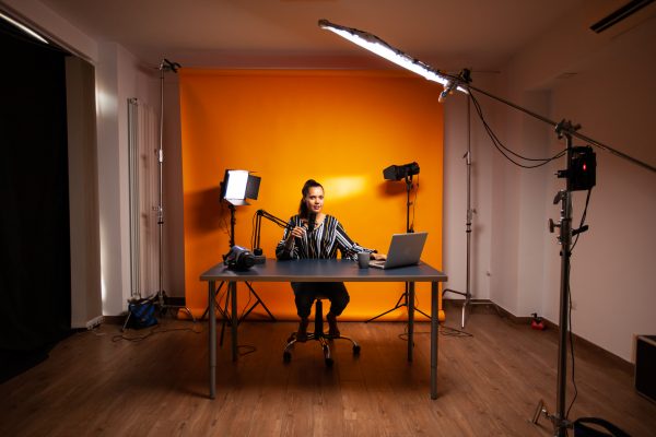 Woman in home studio for filming online content.